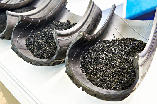 Three rubber tires cut in half with rubber granules inside.