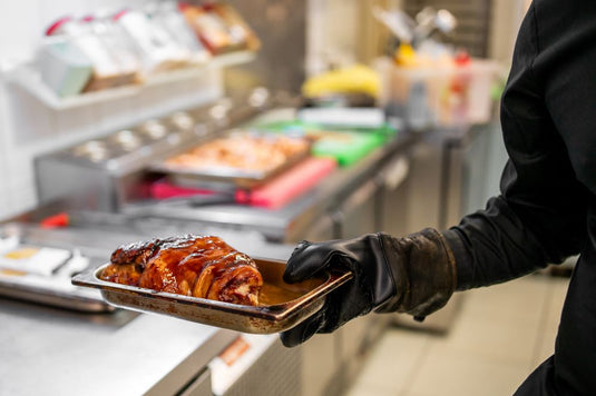 Sliced pork on a tray in a commercial foodservice kitchen