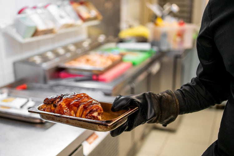 Sliced pork on a tray in a commercial foodservice kitchen