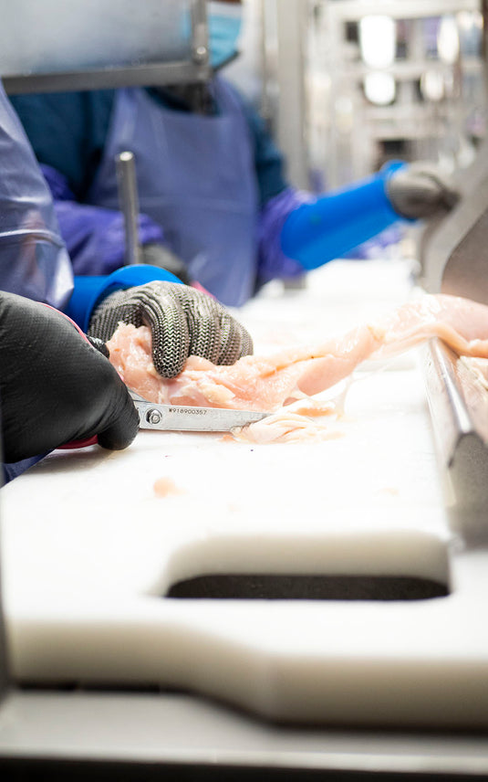Wolff Industries produces the best boning knife for poultry in the business, which helps this worker process meat quickly and efficiently.